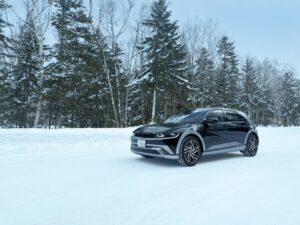 Black suv on a snowy road.